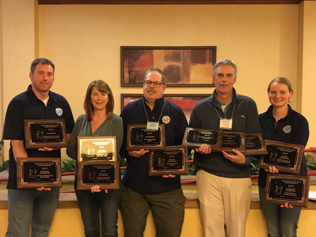 People holding awards at meat competition
