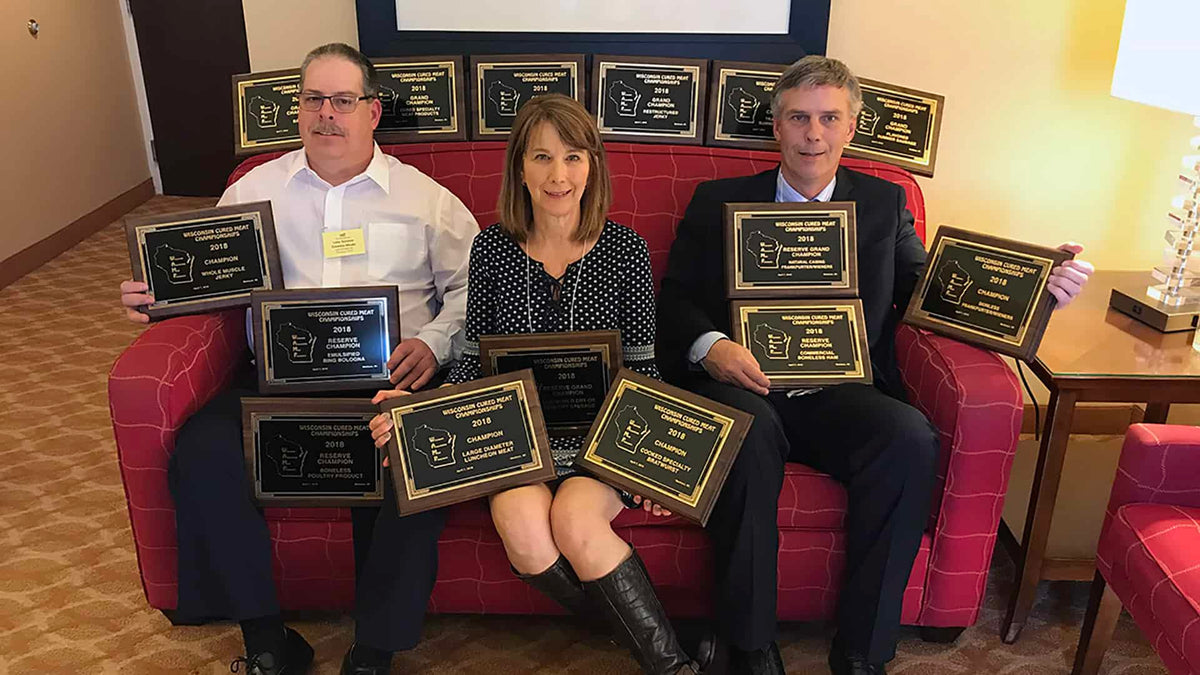 People with awards in hotel room