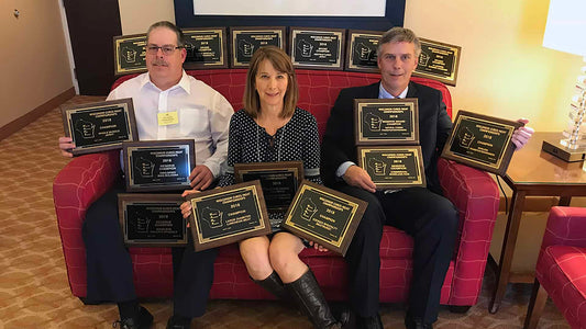 People with awards in hotel room