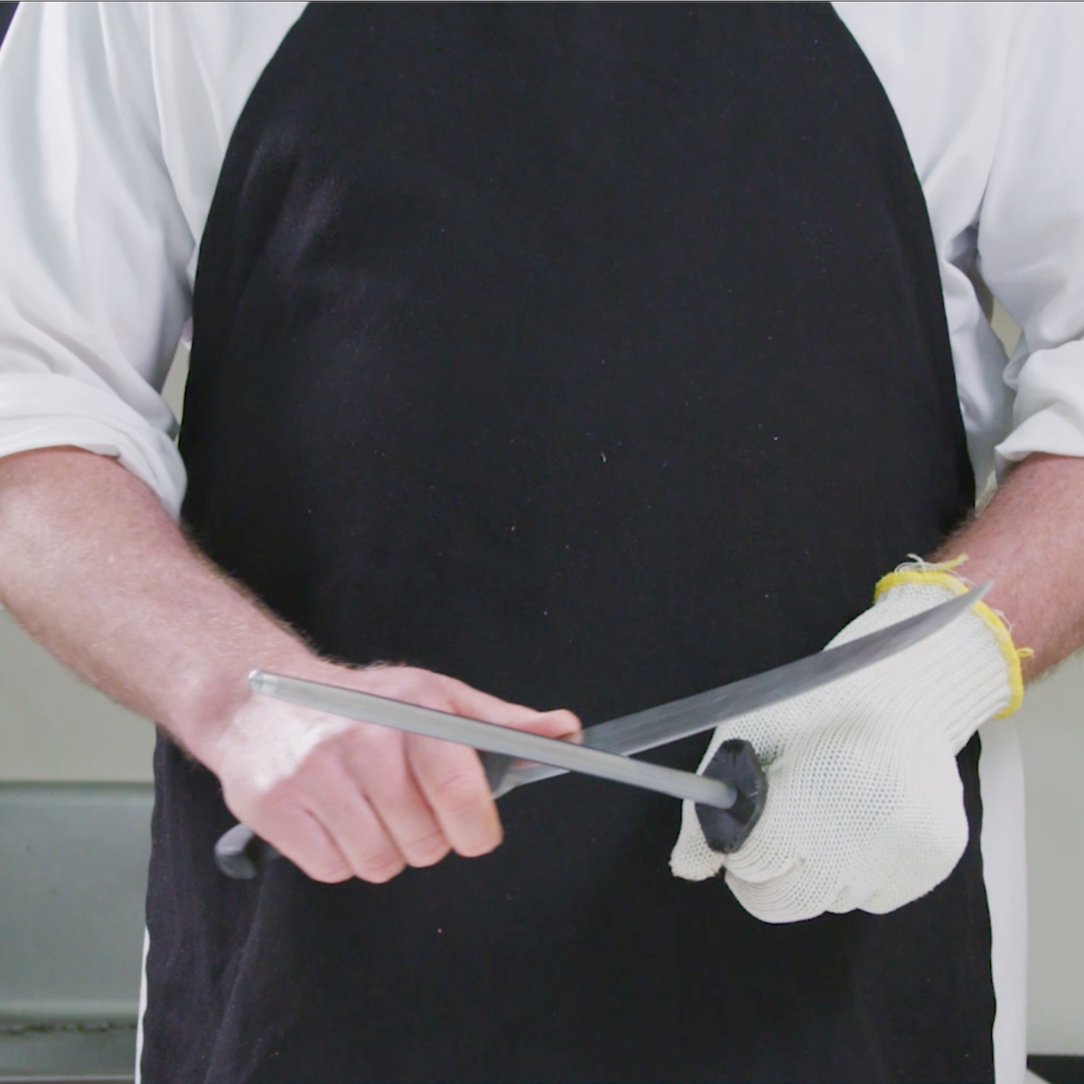 a butcher honing his knife