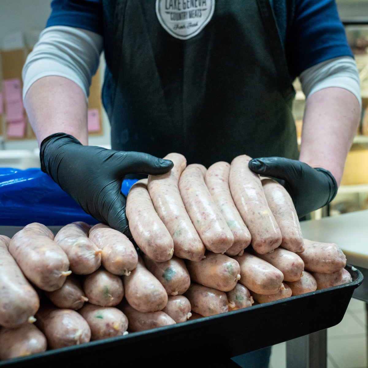 Person Holding Bratwursts In Hand