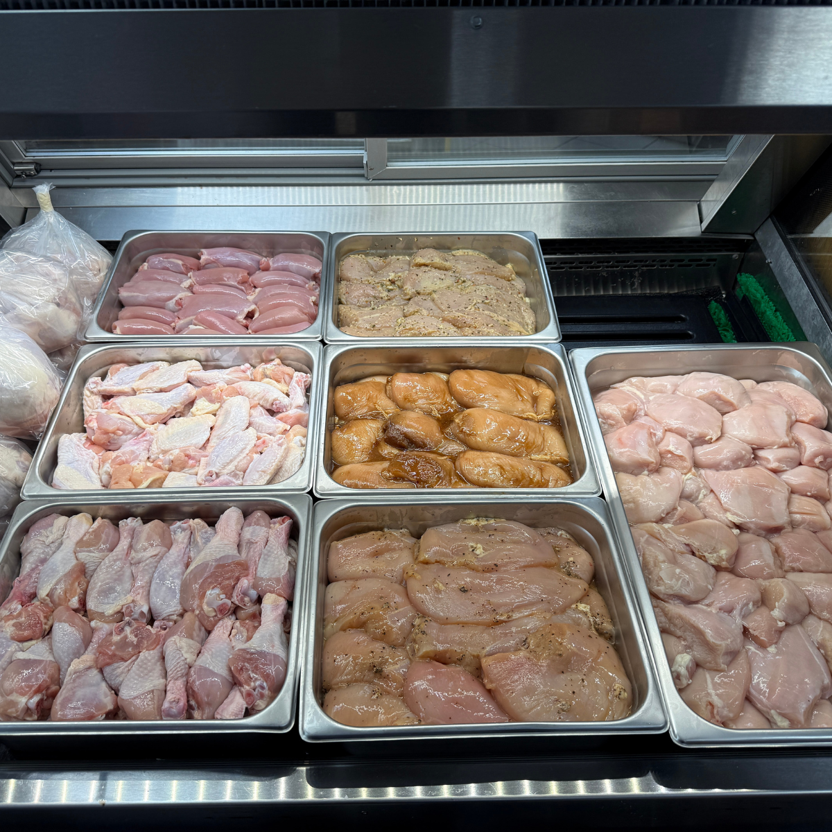raw chicken in meat case