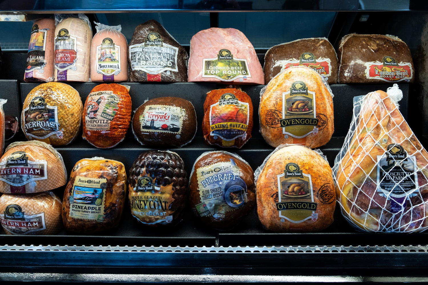 Display of various boar's head deli meats on a shelf