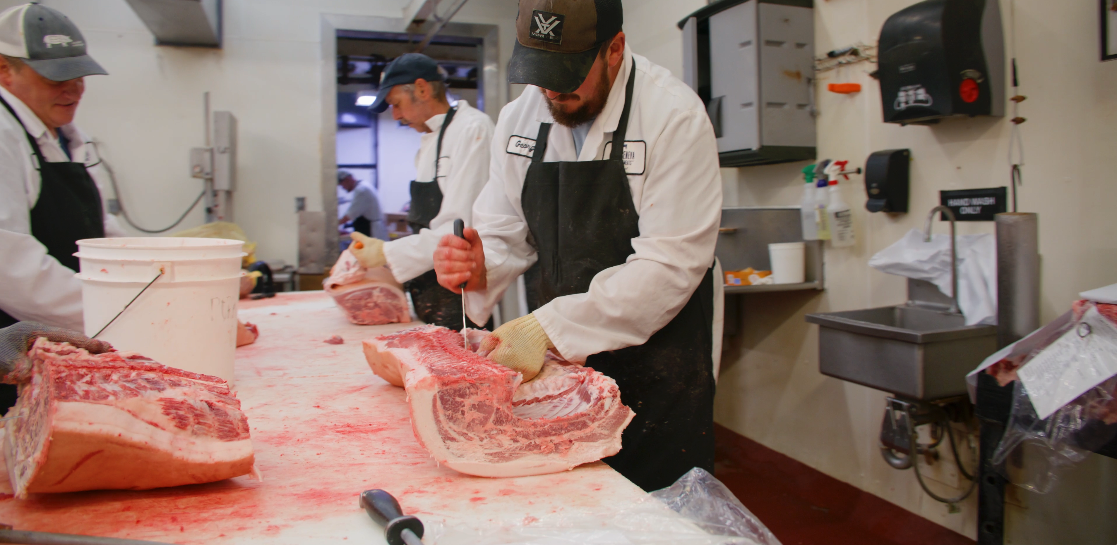 butchers cutting pork on a butcher table