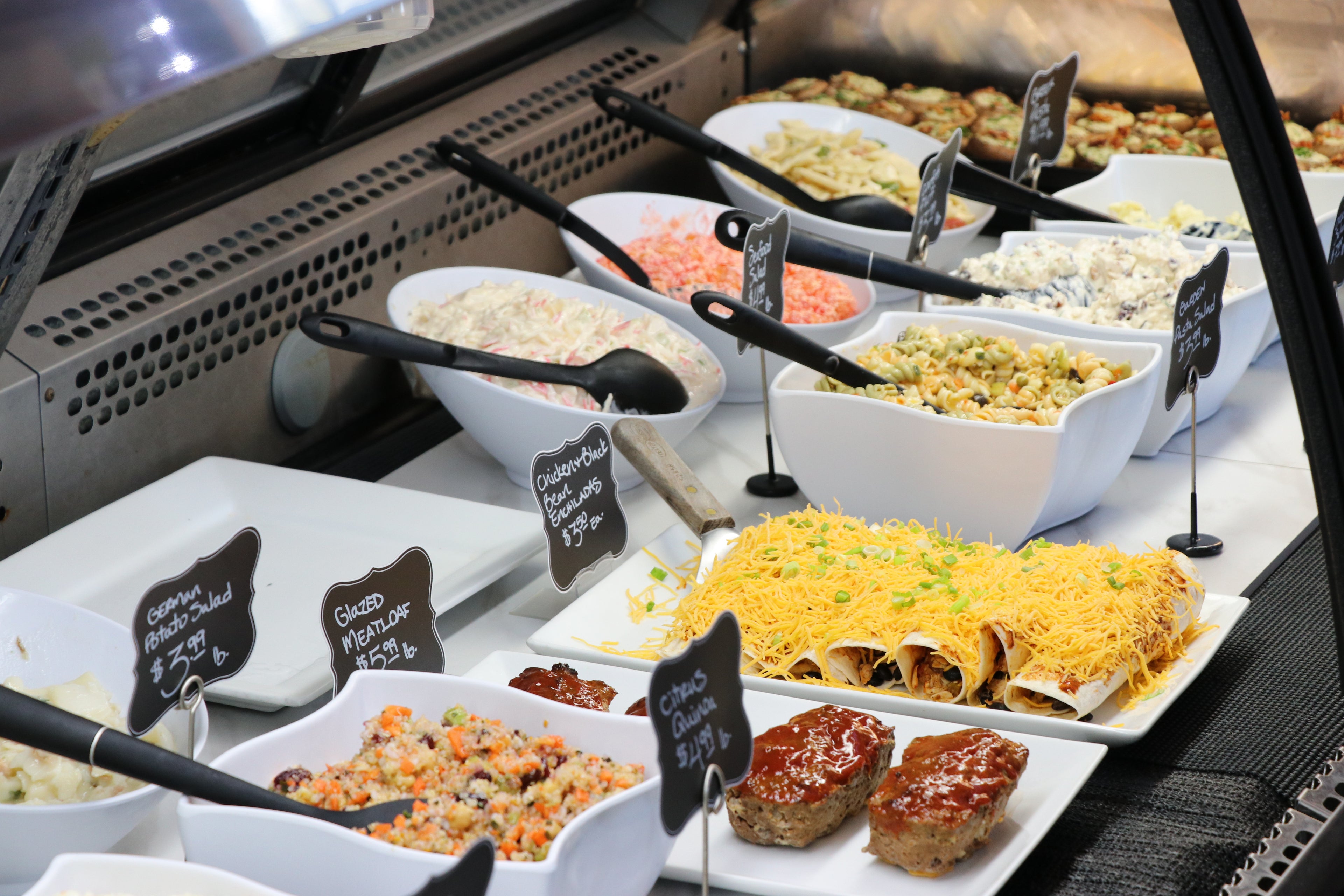deli case with enchiladas and pasta salads