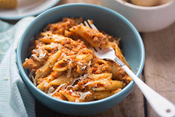 penne pasta in meat sauce in a bowl