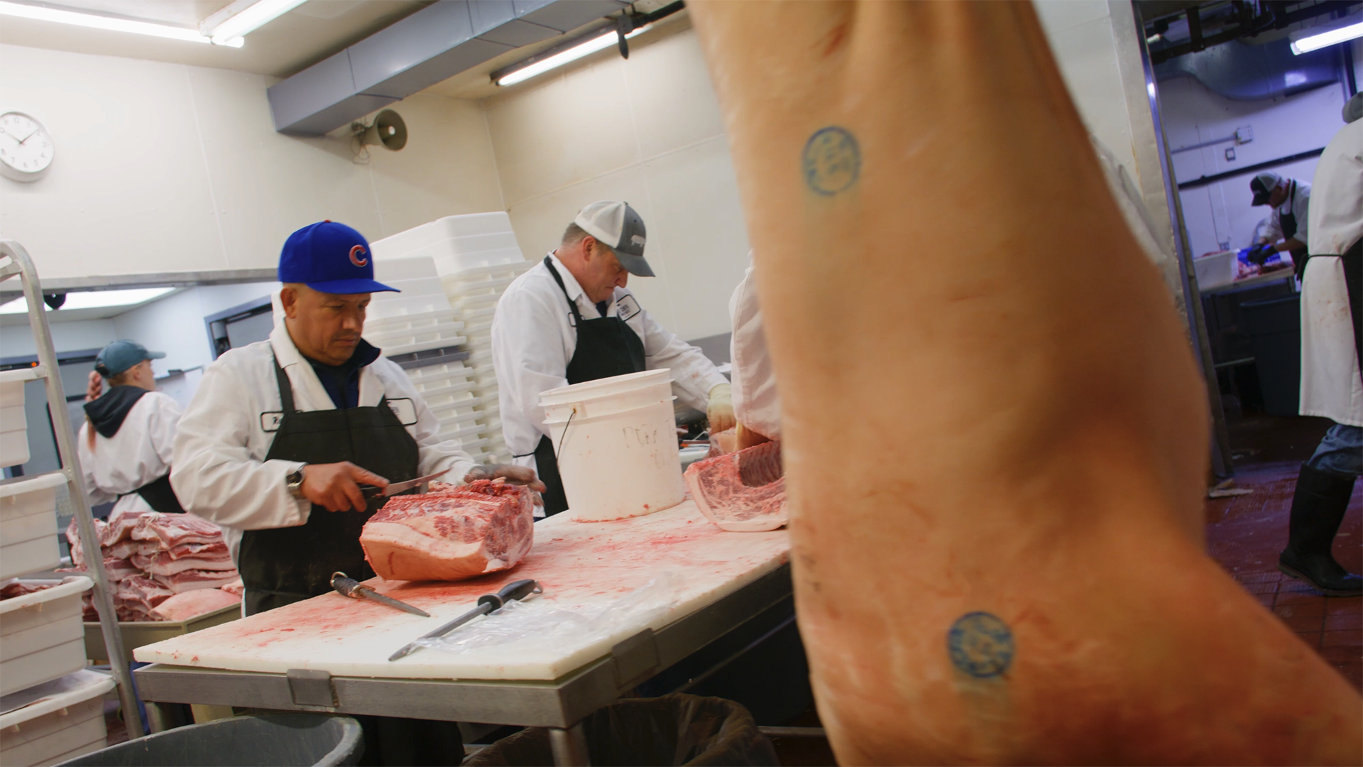 butchering pork on a meat processing floor