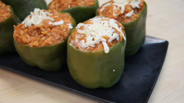 stuffed green peppers with cheese on top