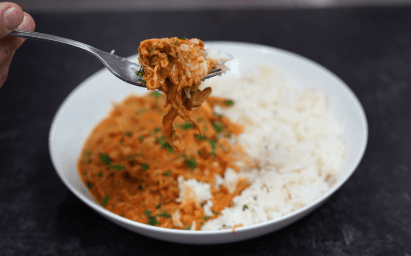 Chicken Tikkia Masala with rice in white bowl