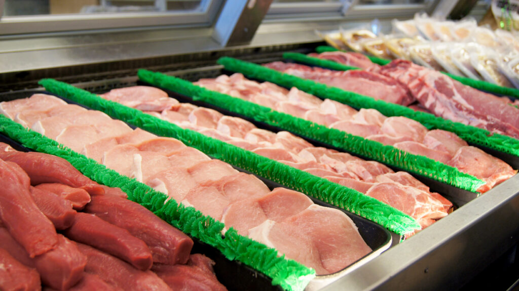 A variety of pork cuts in a meat case