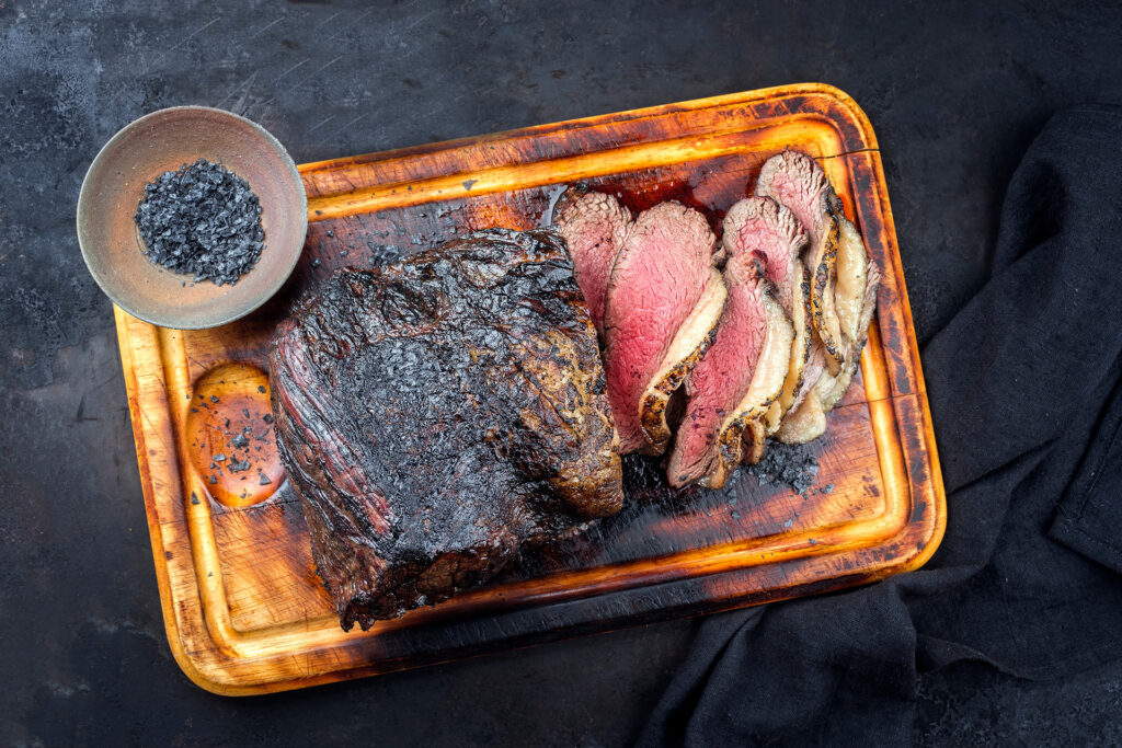Weekly Sales at Lake Geneva Country Meats smoked picanha sliced and served on a cutting board