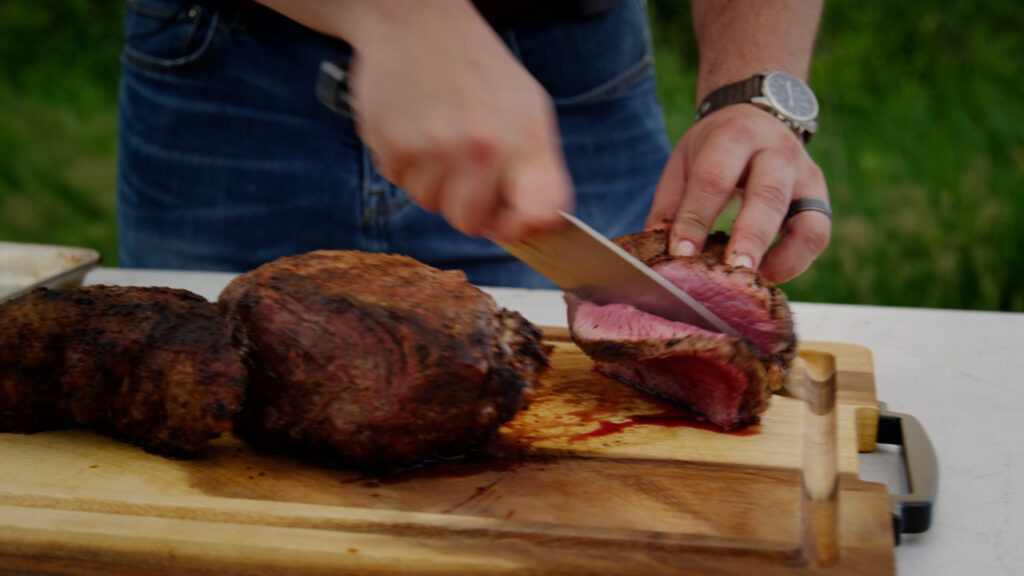 slicing wood fired grill meat